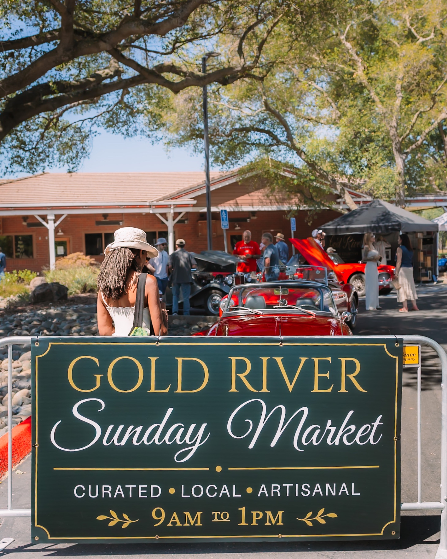 Gold River Sunday Market entrance sign with classic cars beyond